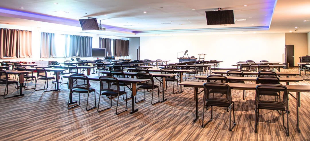 Second-floor lecture hall arranged with classroom tables